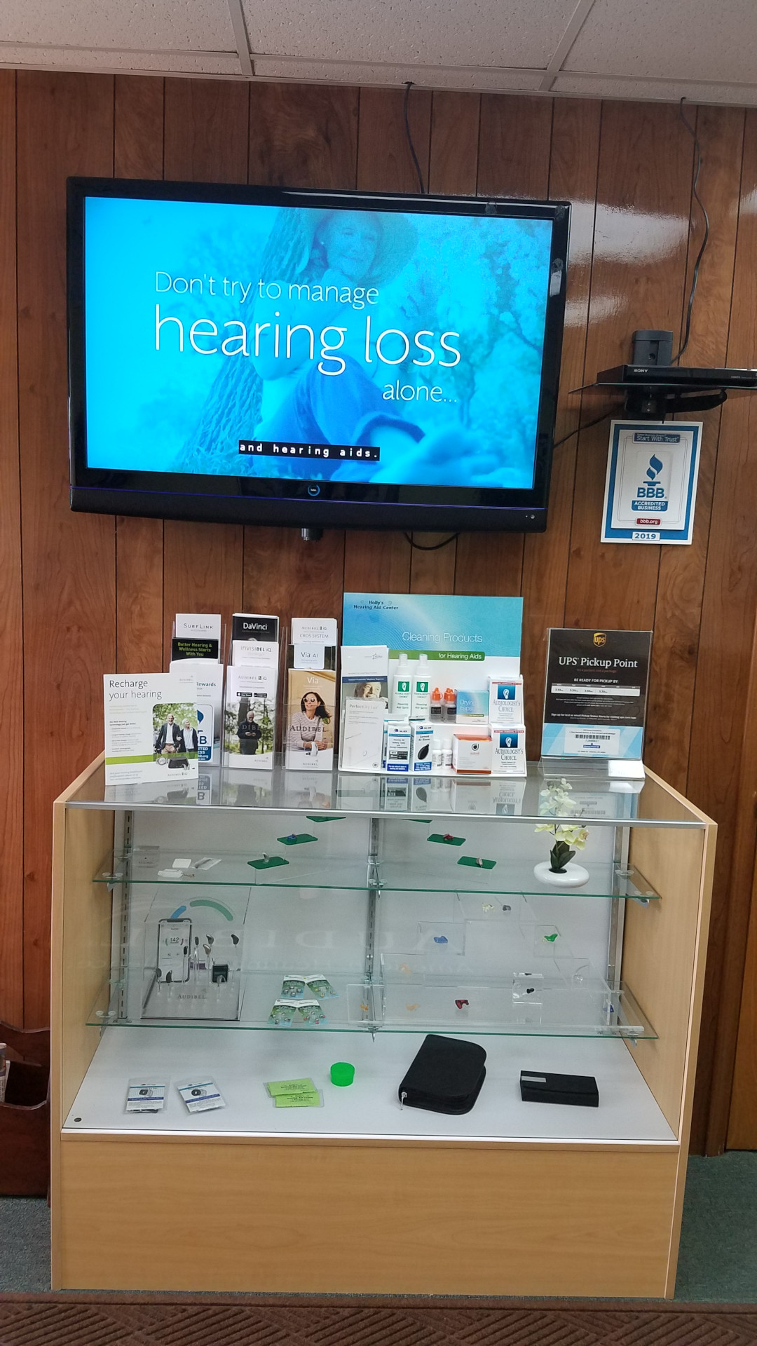 Hearing aid display with brochures on top and screen above