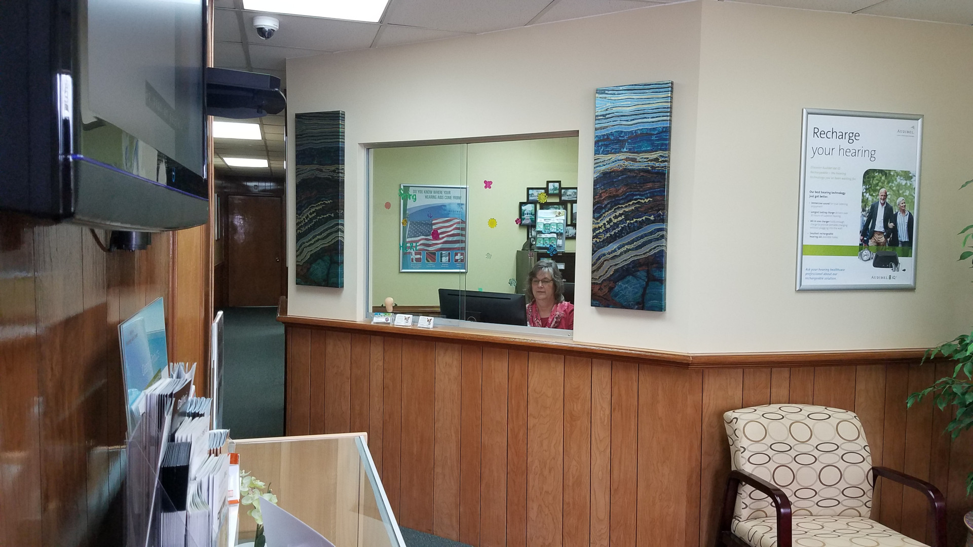 lobby reception window with woman behind desk