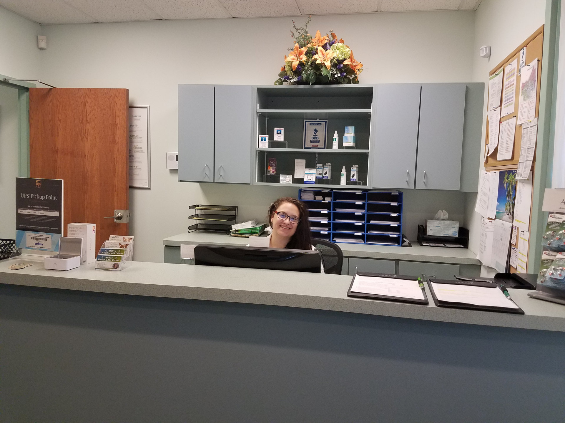 woman working behind front desk at Holly's Hearing Aid Center in Mayfield